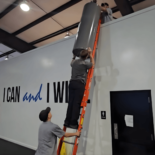 Technicians installing a tankless water heater system to improve energy efficiency and provide reliable hot water